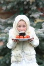 Charming girl in Russian chalet holding a plate with Easter eggs